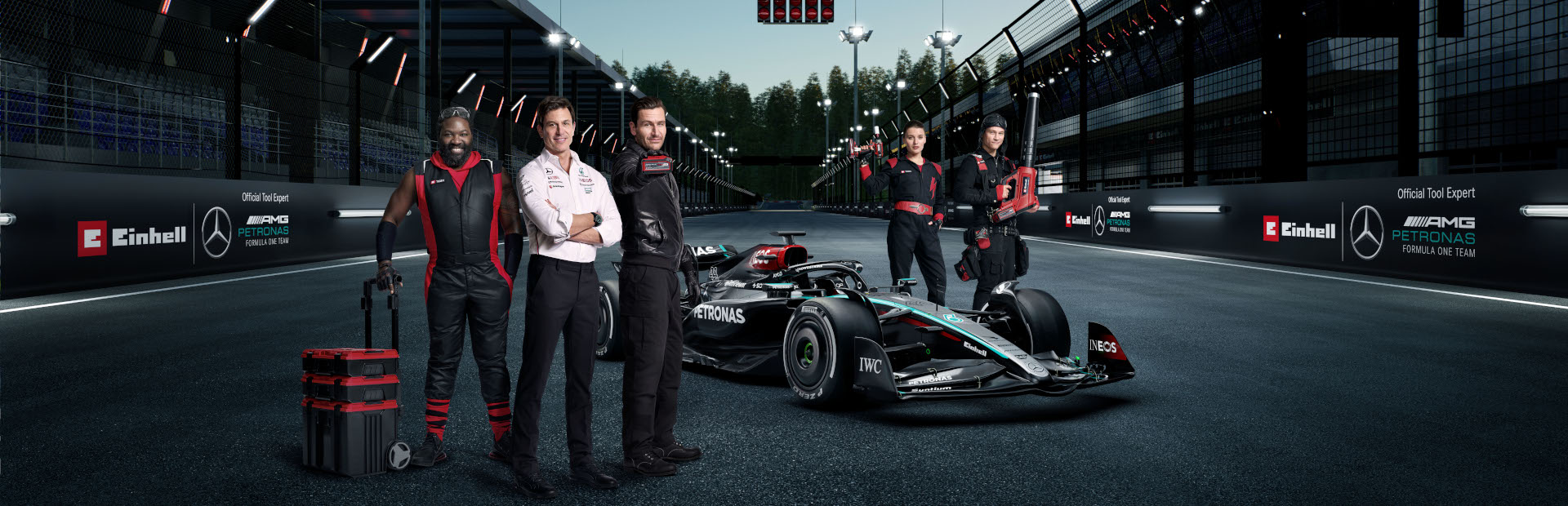 e team members stand around formula 1 car