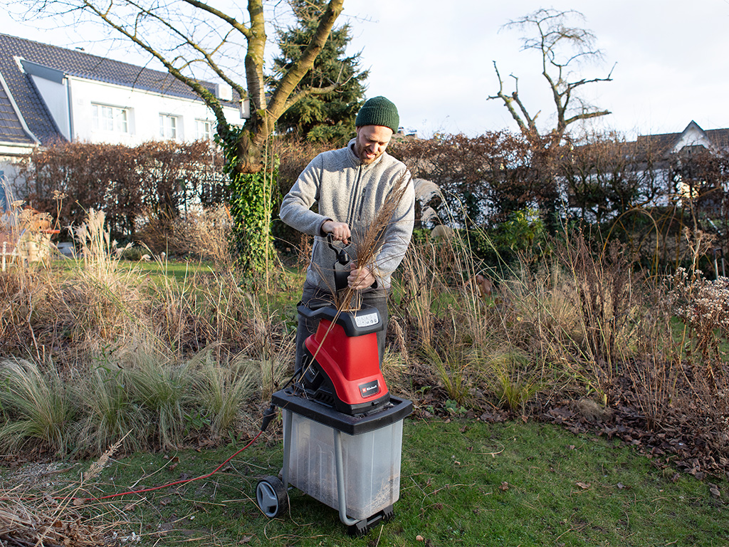 a man chops up branches