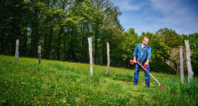 A man trimming the lawn.