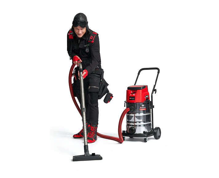 e team member with vacuum cleaner in hand